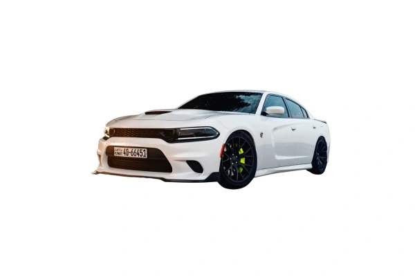 A white sports sedan, likely a Dodge Charger, with black rims and highlighted brake calipers, displayed against a white background. The car features a modern and aggressive design with a black front grille and a lowered body stance, indicating performance-oriented modifications. There are no visible company markings or logos.